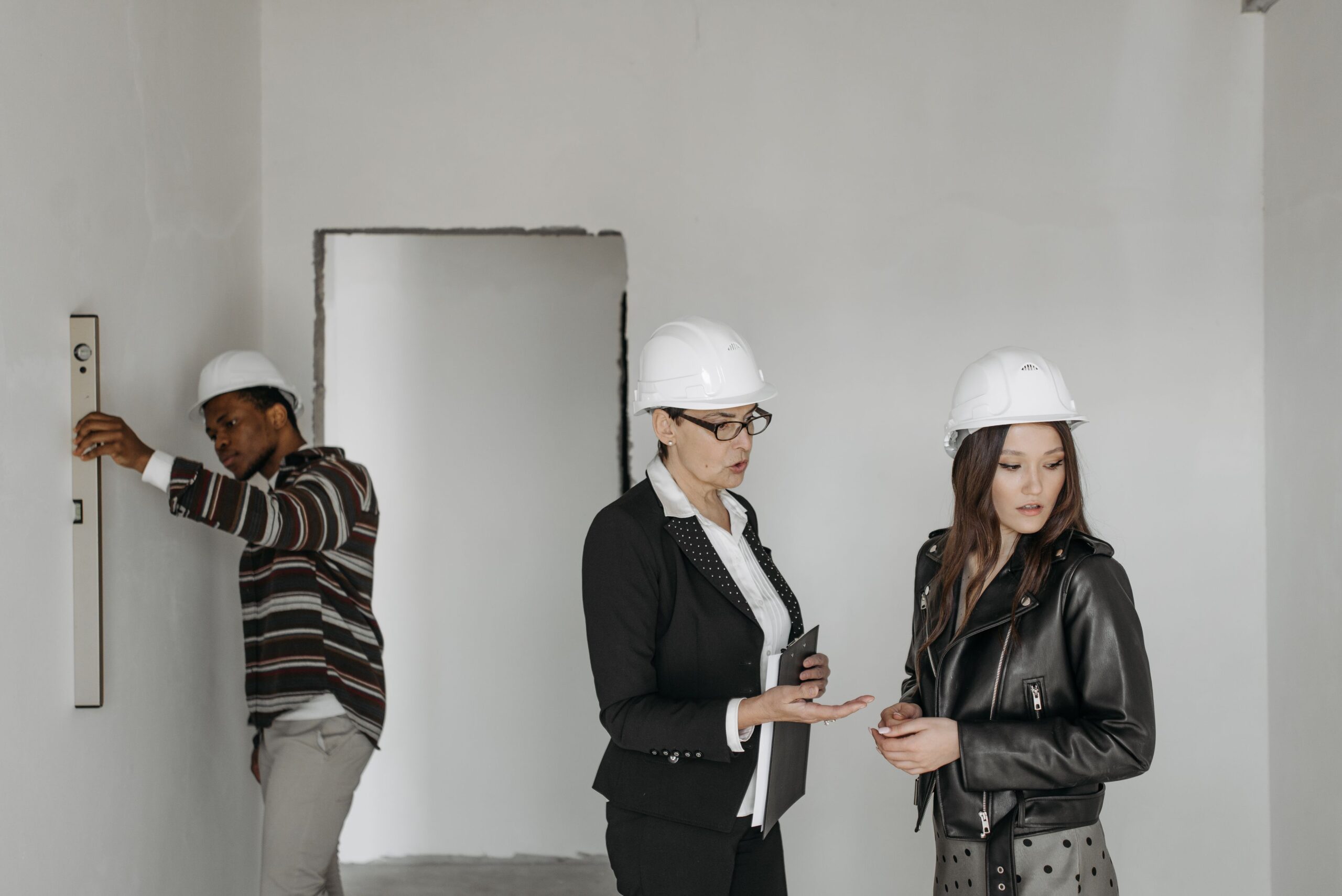 Contractor and client reviewing a jobsite in hard hats