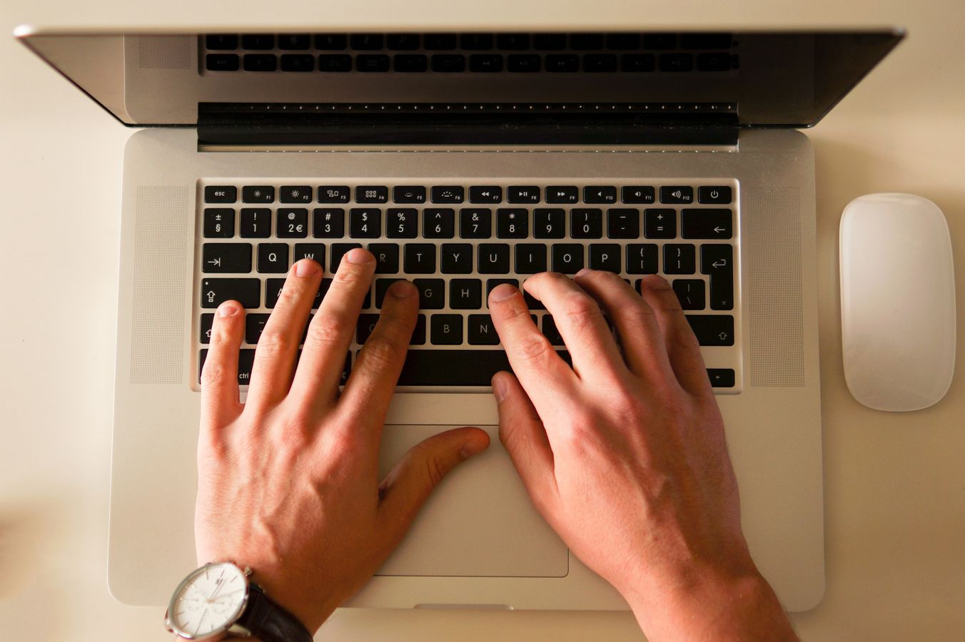 Person writing blog content on a laptop in a home office