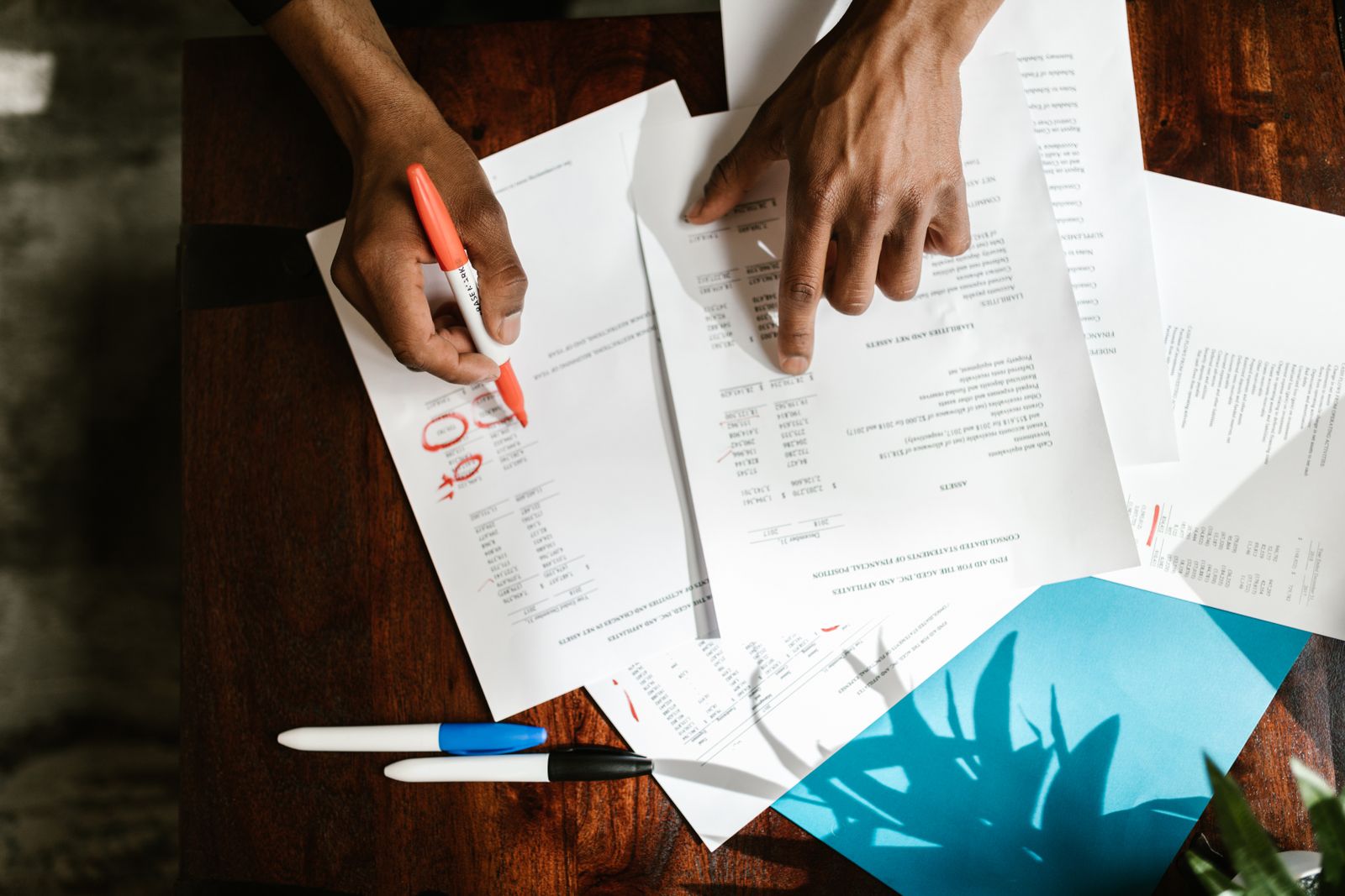 Professional reviewing financial statements and tax paperwork at a desk