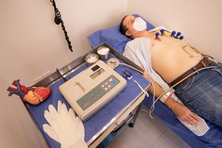 Patient connected to an ECG machine during a cardiology stress test in a clinic exam room