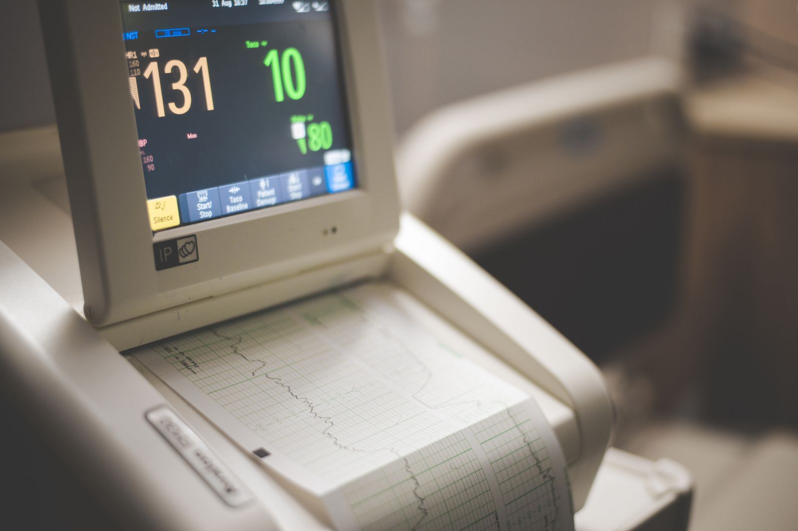 Close-up of a cardiac monitor displaying heart rate and vital sign readings