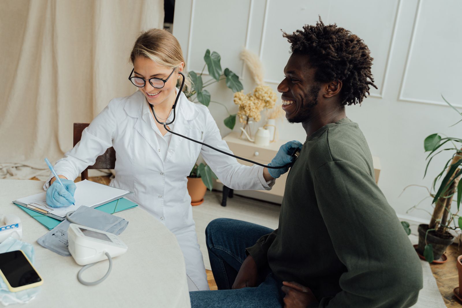 Doctor listening to a patient's heartbeat with a stethoscope during an office visit