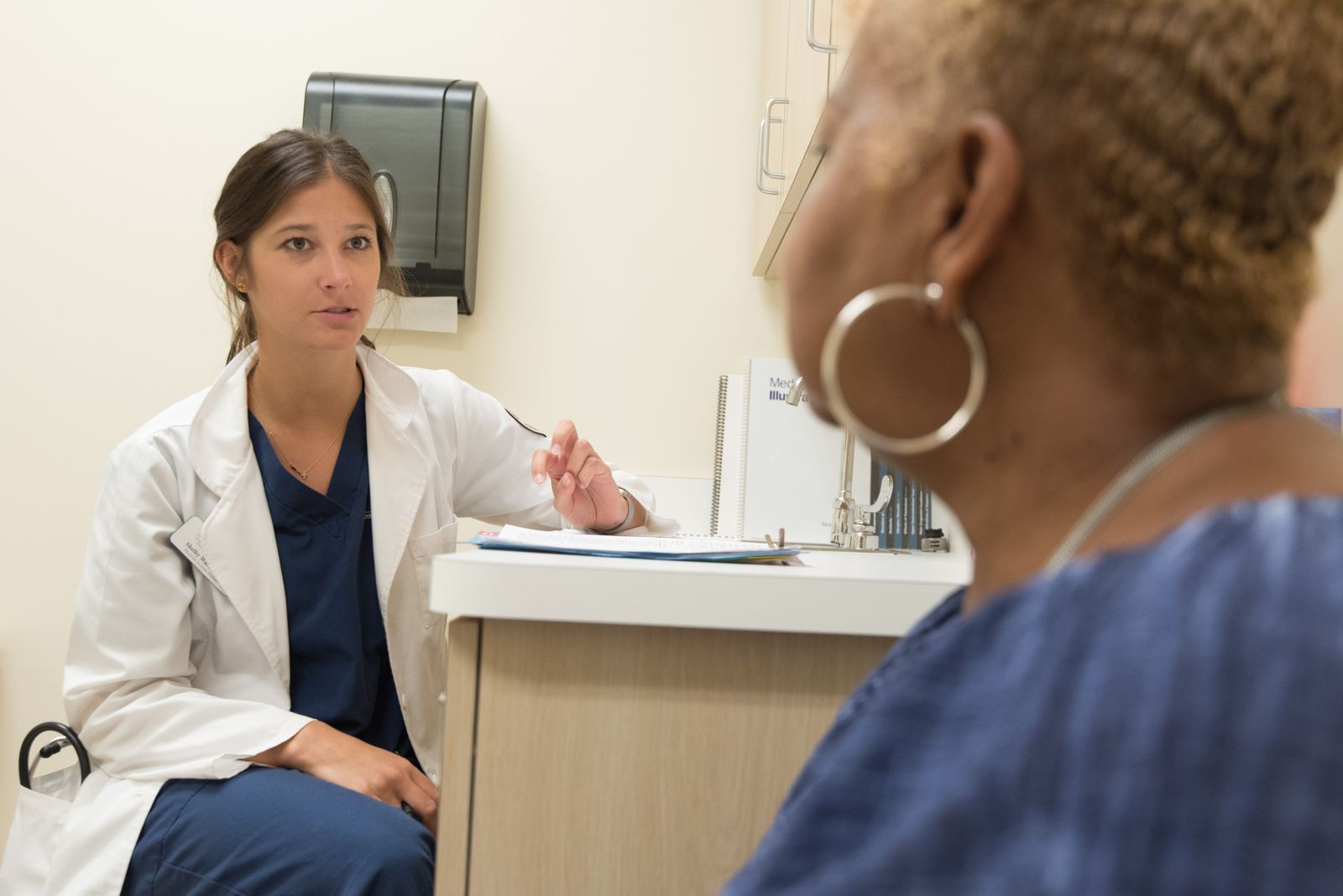 Doctor in white coat explaining treatment options to a patient during an urgent care visit