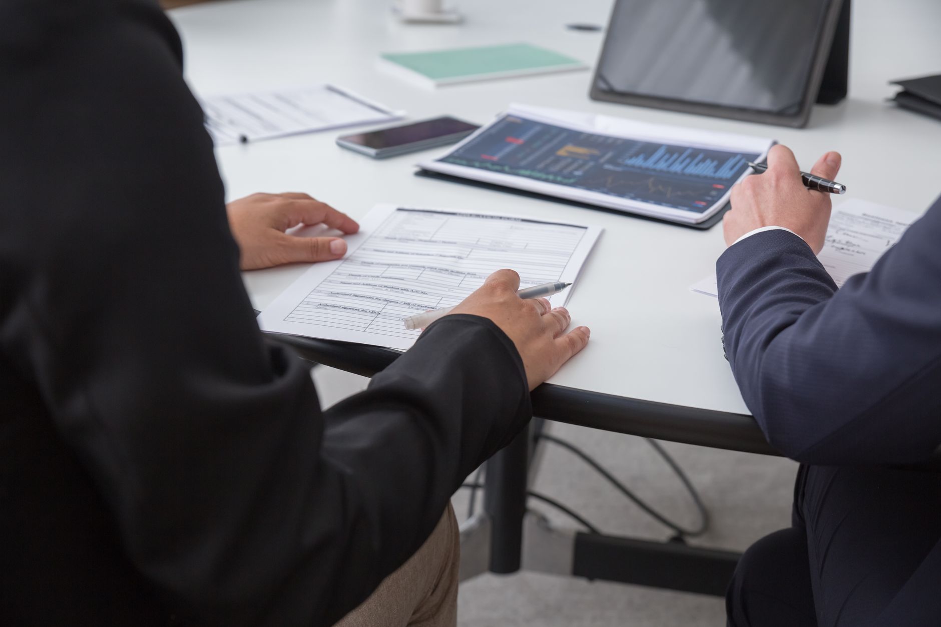 Close-up of a professional reviewing legal documents at a desk
