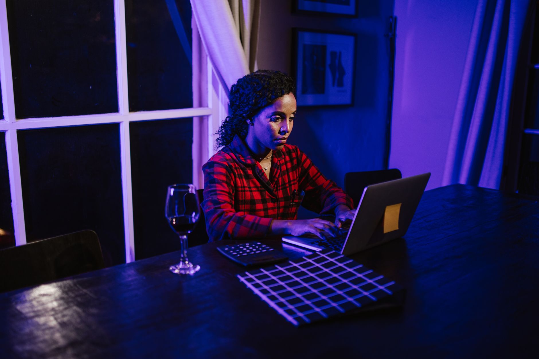 Woman searching for employment lawyer SEO answers on a laptop late at night