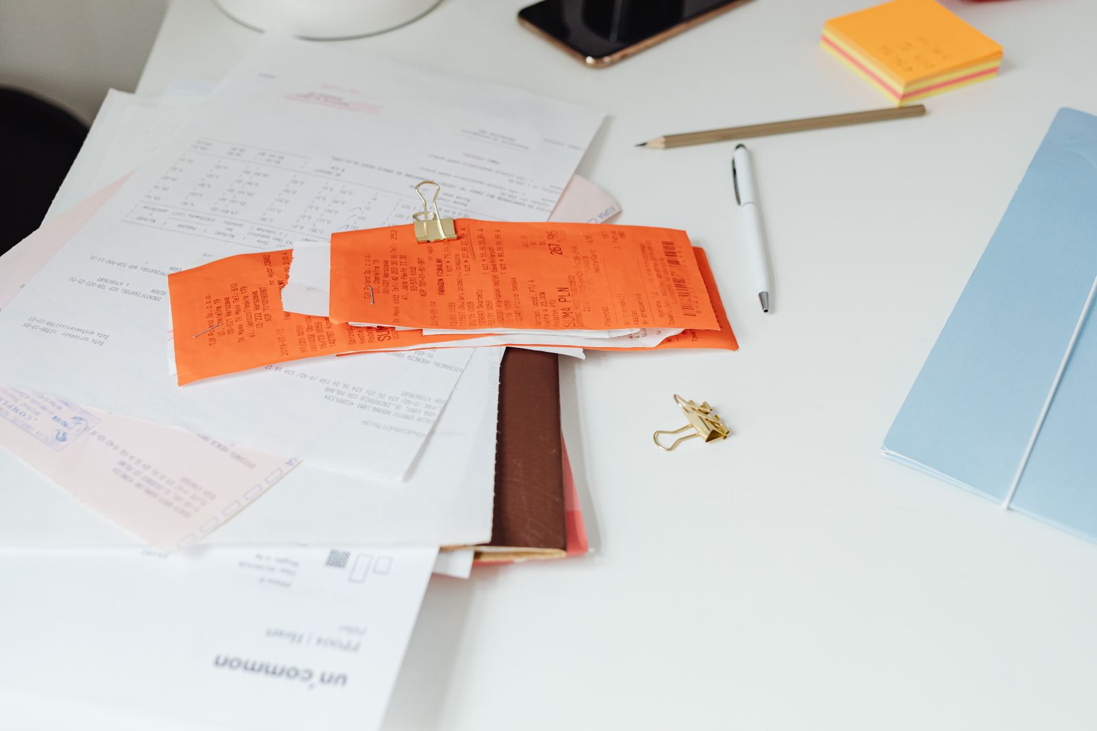 Stack of financial paperwork and IRS notices being organized on a desk