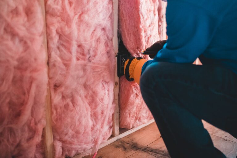 Insulation contractor installing stone wool insulation in a home wall cavity