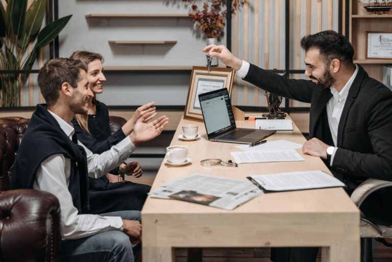Real estate agent meeting with clients in a modern office discussing a property purchase