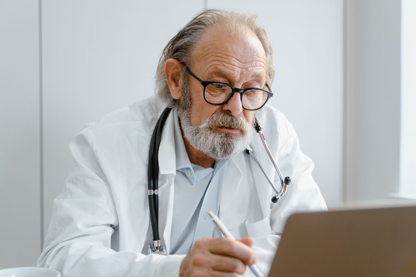 Doctor reviewing patient search and review data on a laptop