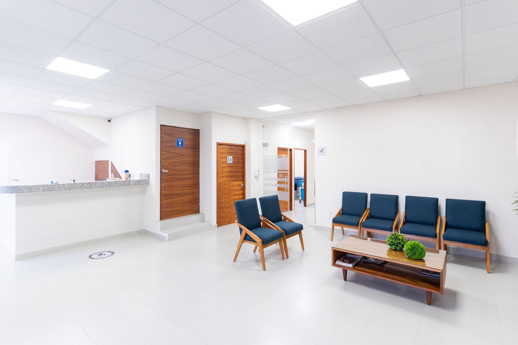 A bright, clean medical clinic waiting room with modern seating