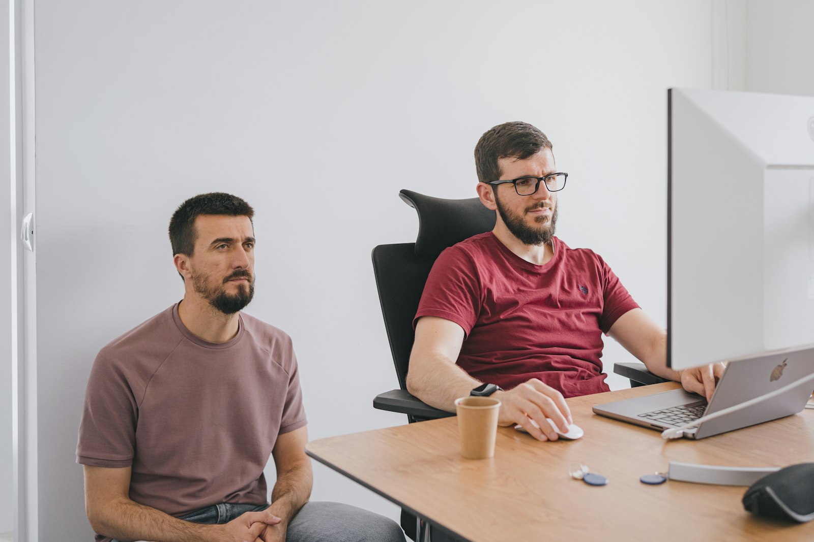 Two IT business partners reviewing a managed services proposal together at a desk