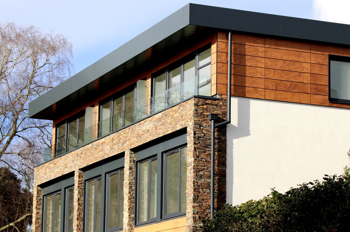 Modern house with large energy-efficient windows on a sunny day
