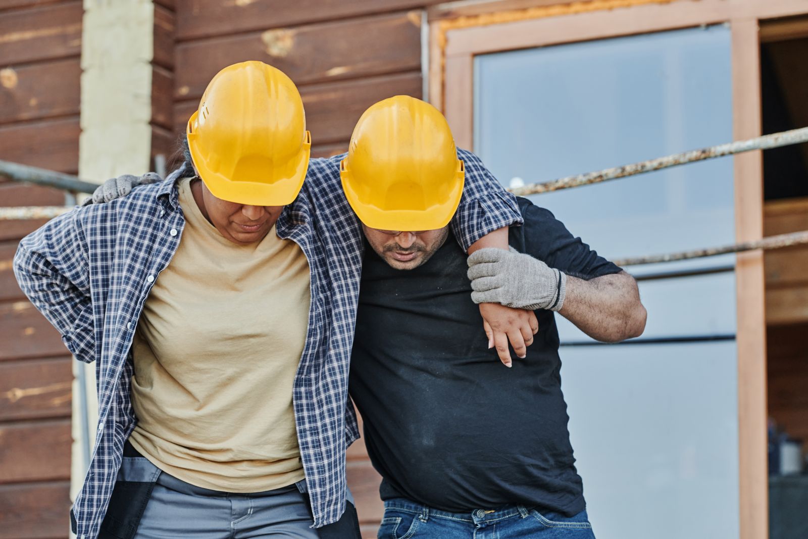 Construction workers wearing hard hats at a job site, representing the kind of workplace injury that leads to a workers compensation claim