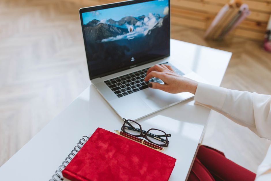 Writing fertility clinic blogging content on a laptop at a desk