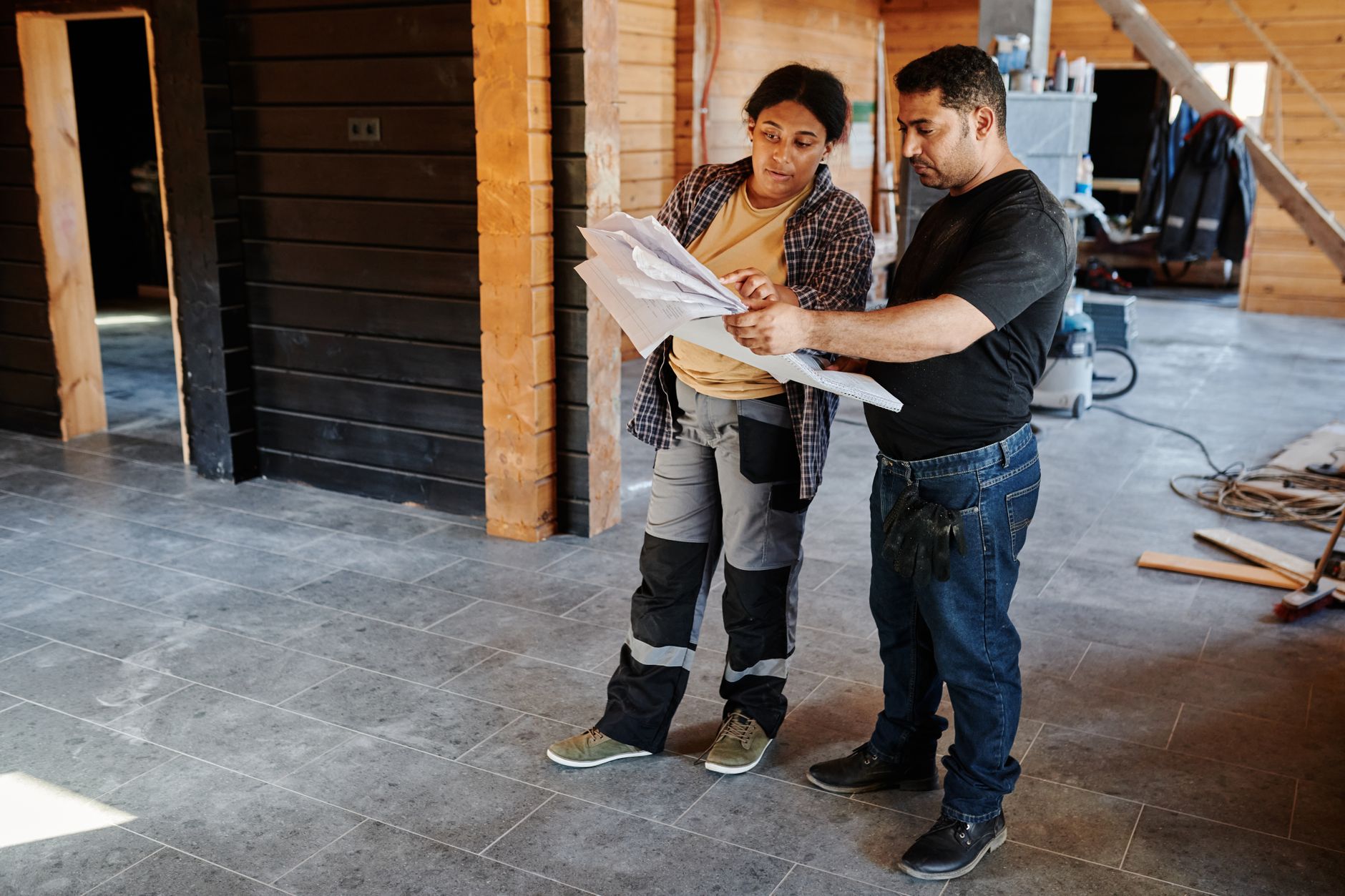 Contractor measuring and planning a home renovation and insulation upgrade