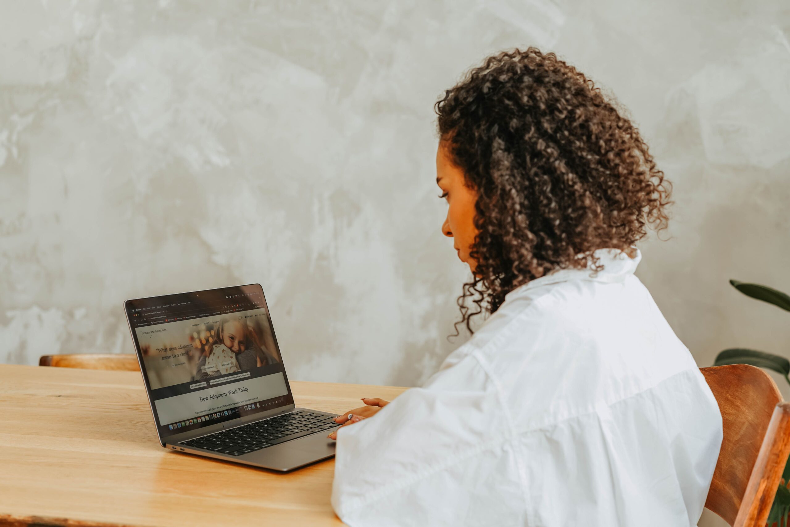 A woman researching online using her laptop