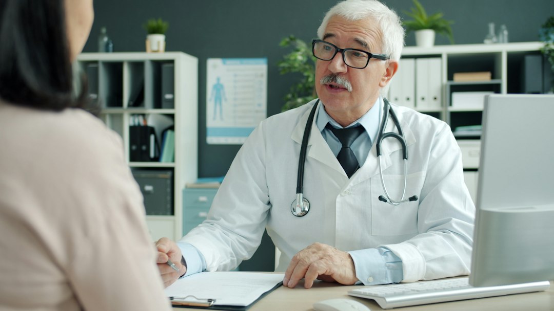 Doctor sitting down for a consultation with a female patient
