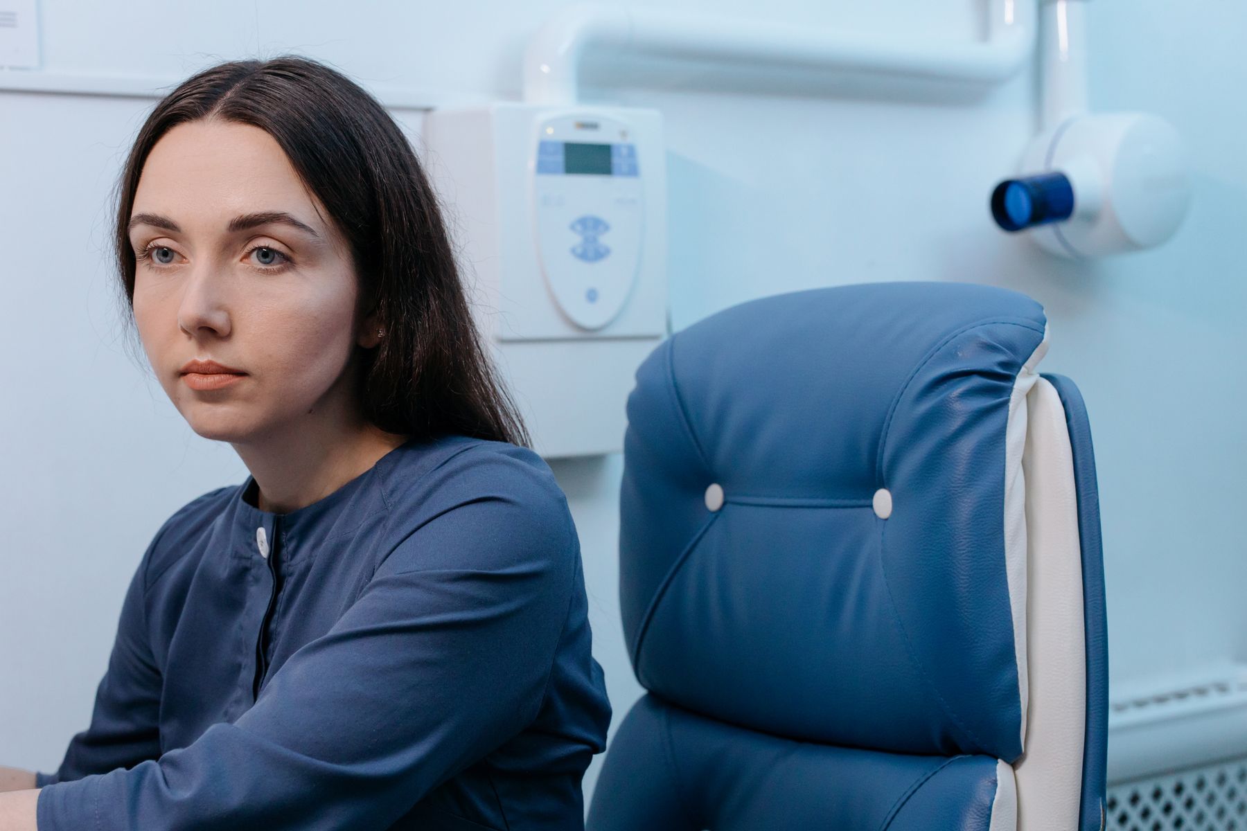 Patient sitting thoughtfully in a GI clinic waiting room