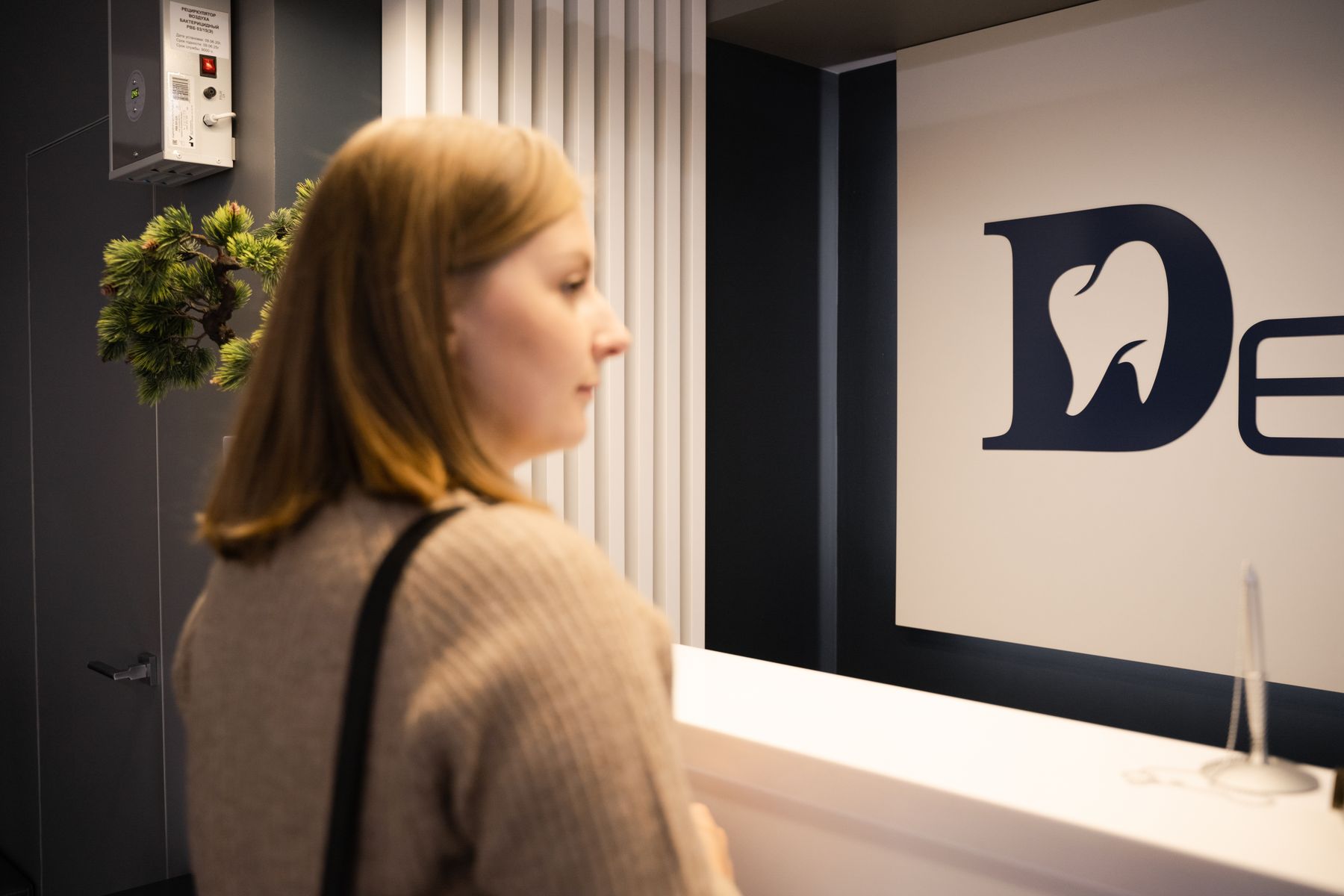 Patient checking in at an oral surgery office reception desk