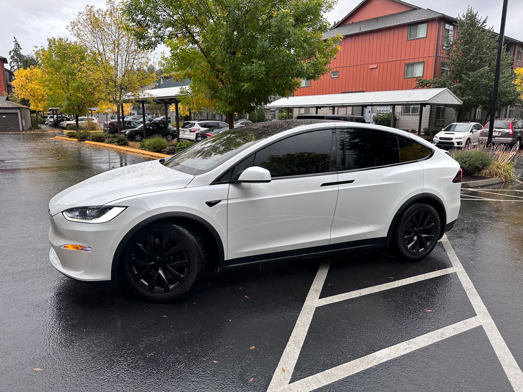 A vehicle with professionally tinted windows parked outside a building