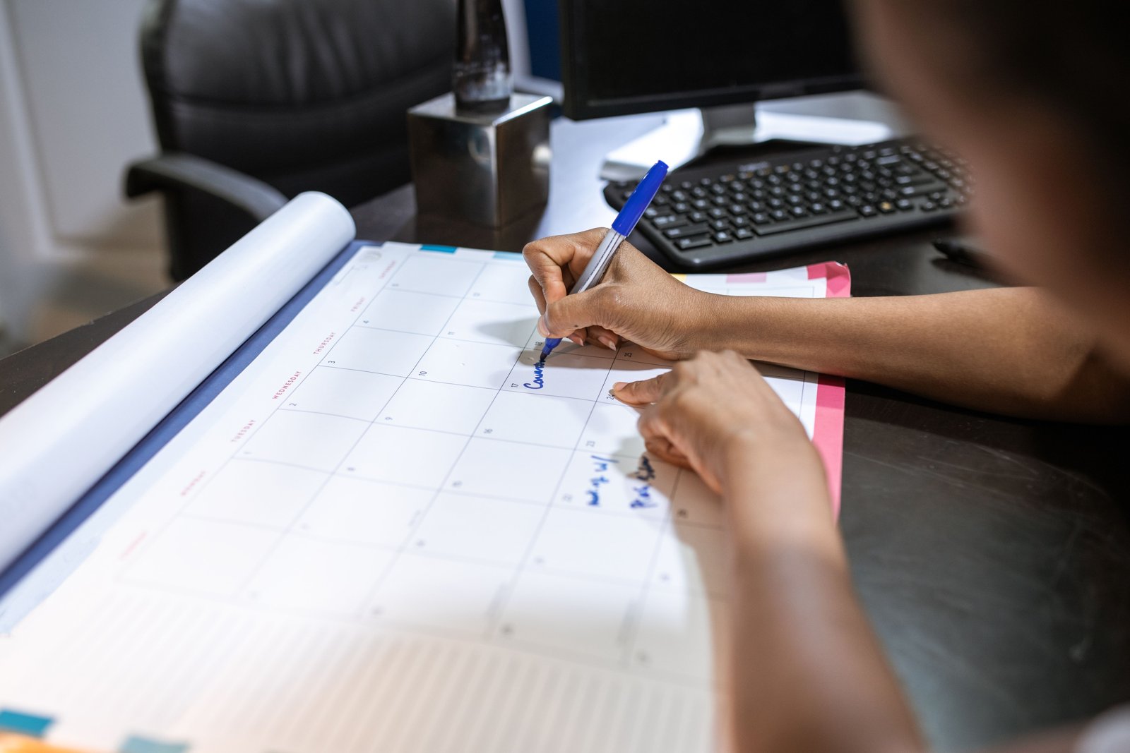 A wall calendar with planning notes marking out a monthly publishing schedule