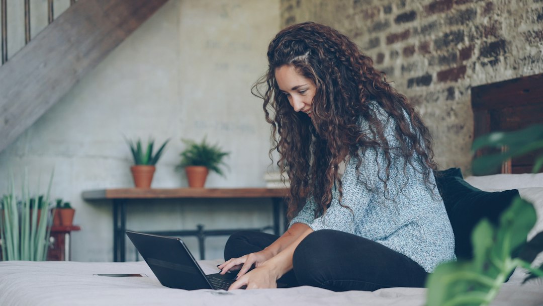 Woman searching for information on a laptop at home