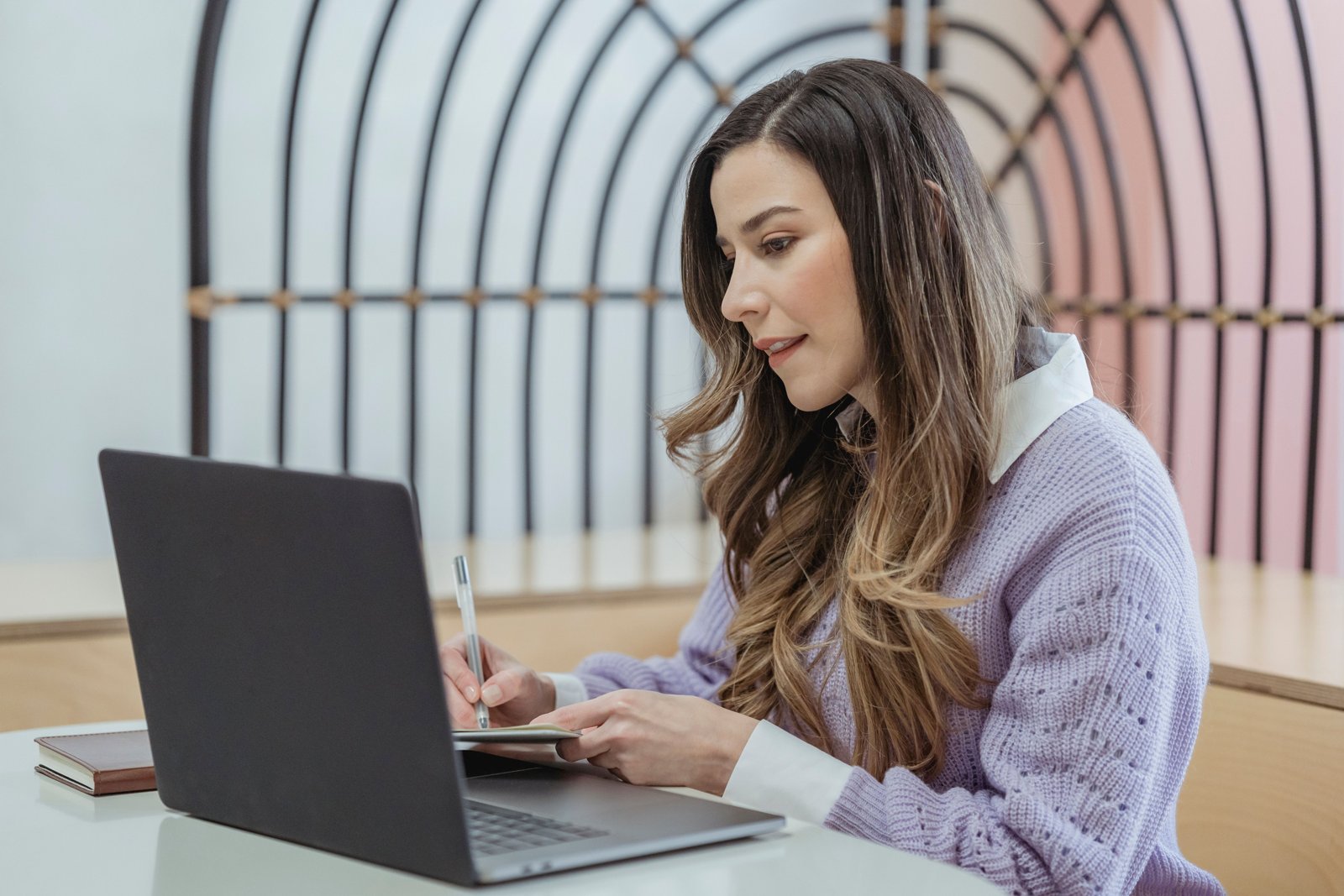 A business owner writing out blog topics at her desk