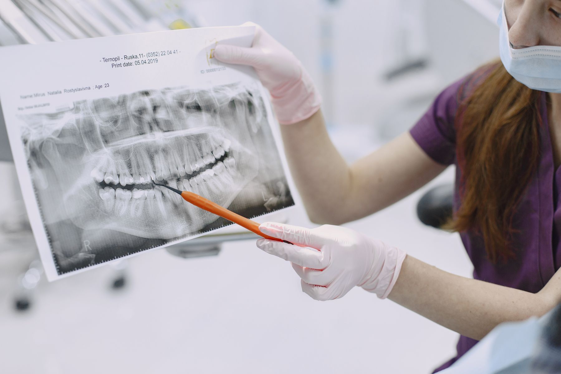 Dentist showing a patient their dental X-ray results during a consultation